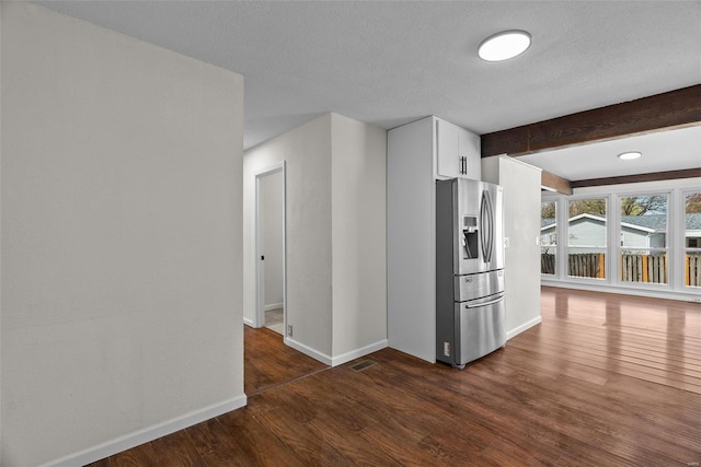 7 Beavertail Ct, Florissant, MO 63033 - kitchen with stainless steel fridge with ice dispenser, dark wood finished floors, beam ceiling, baseboards, and a textured ceiling