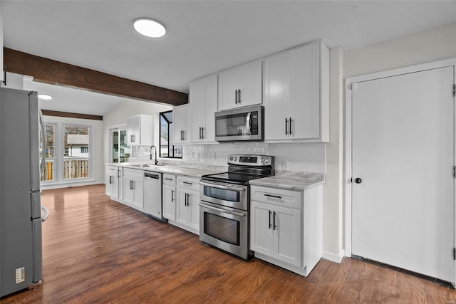7 Beavertail Ct, Florissant, MO 63033 - kitchen with appliances with stainless steel finishes, tasteful backsplash, a sink, and white cabinets