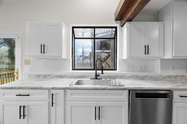 7 Beavertail Ct, Florissant, MO 63033 - kitchen featuring stainless steel dishwasher, a sink, white cabinetry, and backsplash