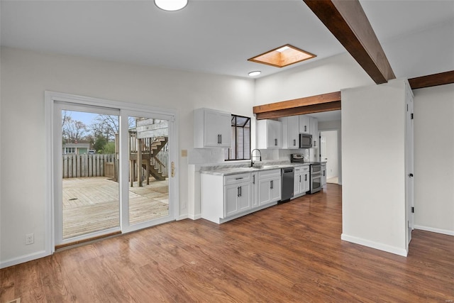 7 Beavertail Ct, Florissant, MO 63033 - kitchen with appliances with stainless steel finishes, a sink, dark wood-type flooring, and baseboards