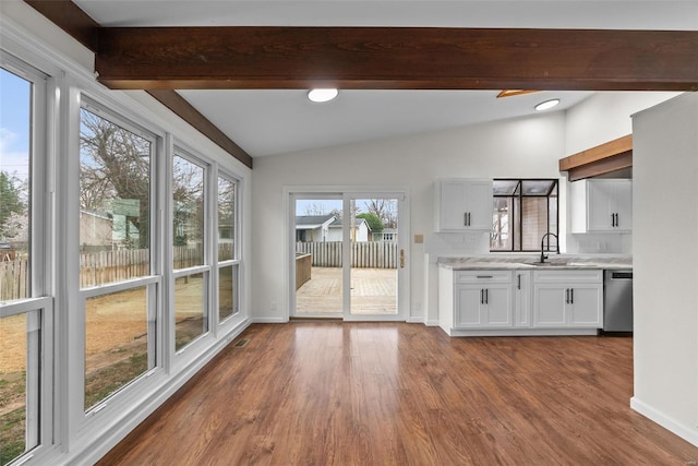 7 Beavertail Ct, Florissant, MO 63033 - kitchen with stainless steel dishwasher, dark wood-style floors, white cabinets, a sink, and baseboards