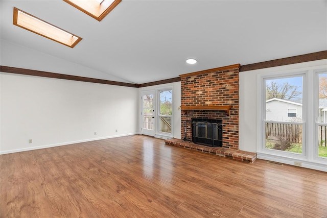 7 Beavertail Ct, Florissant, MO 63033 - unfurnished living room with a skylight, wood finished floors, vaulted ceiling, baseboards, and crown molding