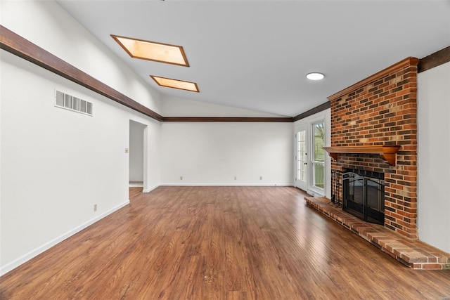 7 Beavertail Ct, Florissant, MO 63033 - unfurnished living room with lofted ceiling, a fireplace, wood finished floors, and baseboards