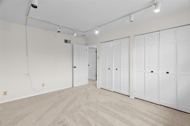 7 Beavertail Ct, Florissant, MO 63033 - unfurnished bedroom with two closets, carpet, rail lighting, and baseboards