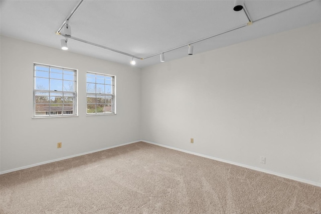 7 Beavertail Ct, Florissant, MO 63033 - spare room featuring carpet floors, baseboards, and track lighting