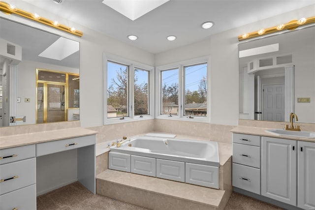 7 Beavertail Ct, Florissant, MO 63033 - bathroom featuring a skylight, vanity, a stall shower, a bath, and recessed lighting