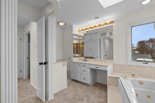 7 Beavertail Ct, Florissant, MO 63033 - bathroom with a tub with jets, a skylight, and vanity