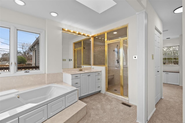 7 Beavertail Ct, Florissant, MO 63033 - full bath with a shower stall, a skylight, vanity, and a bath