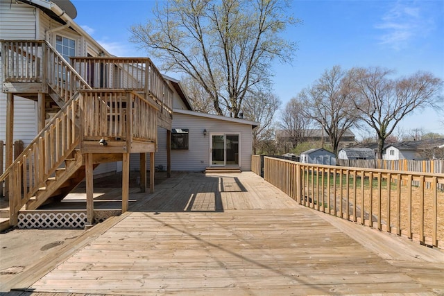 7 Beavertail Ct, Florissant, MO 63033 - wooden deck featuring stairway, an outbuilding, a storage shed, and fence