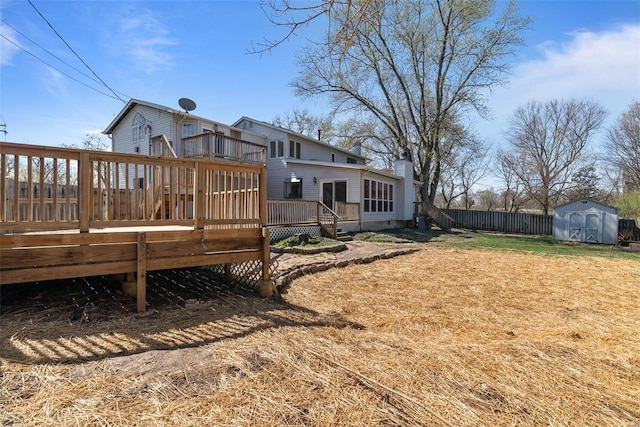 7 Beavertail Ct, Florissant, MO 63033 - view of yard featuring a storage unit, an outdoor structure, fence, a wooden deck, and a balcony