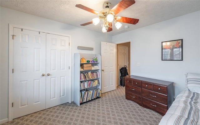 1205 Britt Ln, Rolla, MO 65401 - bedroom with light colored carpet, a closet, a textured ceiling, and ceiling fan