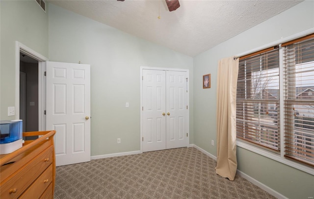 1205 Britt Ln, Rolla, MO 65401 - unfurnished bedroom with lofted ceiling, carpet flooring, a closet, baseboards, and a textured ceiling