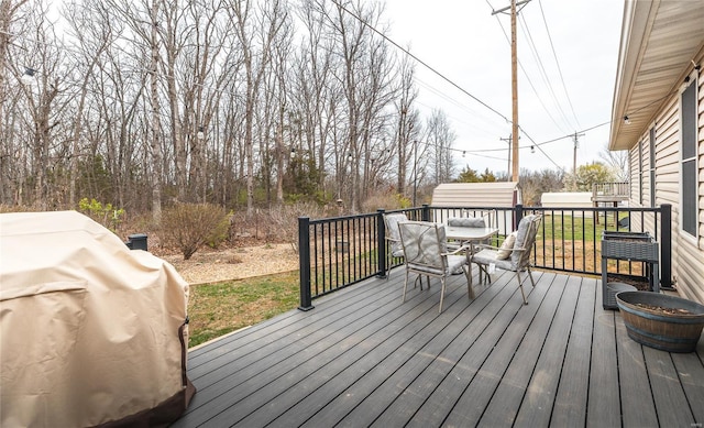 1205 Britt Ln, Rolla, MO 65401 - deck featuring outdoor dining space and an outbuilding