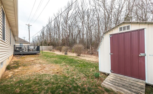1205 Britt Ln, Rolla, MO 65401 - view of green lawn featuring a storage shed, a wooden deck, and an outbuilding