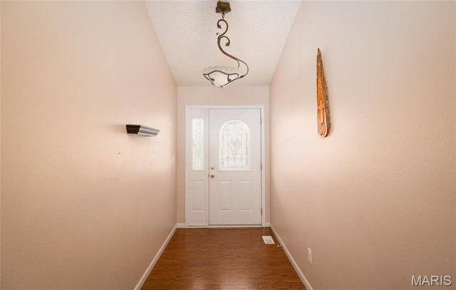 1205 Britt Ln, Rolla, MO 65401 - doorway to outside featuring wood finished floors and vaulted ceiling