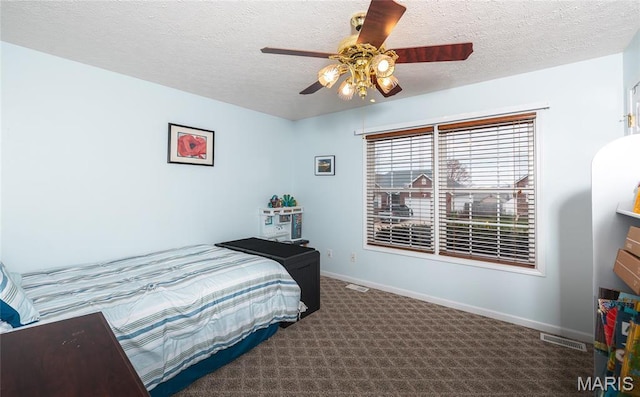 1205 Britt Ln, Rolla, MO 65401 - carpeted bedroom featuring a textured ceiling and ceiling fan
