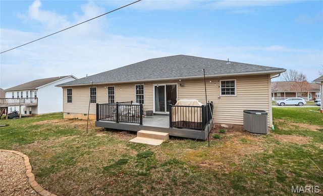 1205 Britt Ln, Rolla, MO 65401 - back of house with a wooden deck, a yard, and roof with shingles