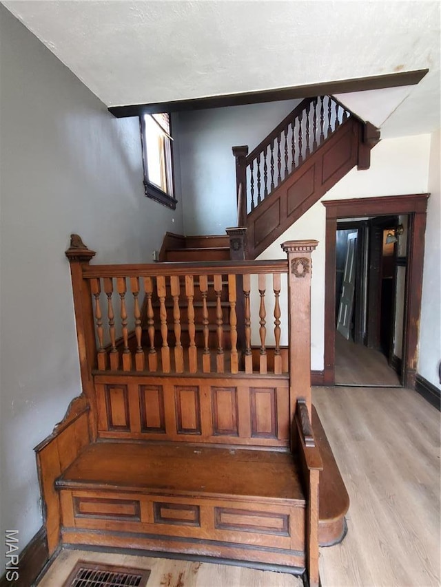 stairs featuring wood finished floors and baseboards