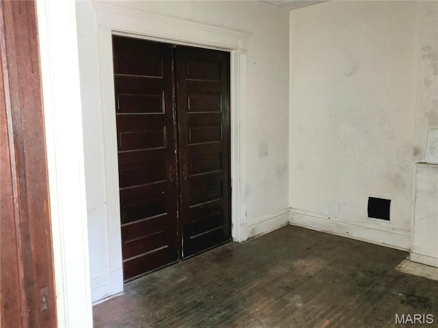 unfurnished room with wood finished floors and baseboards