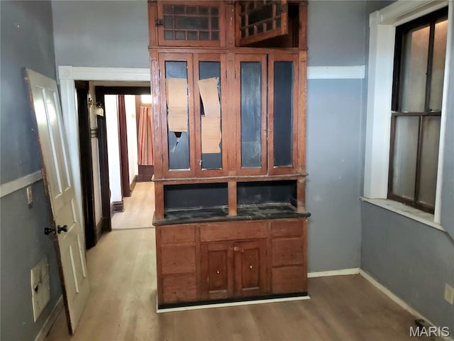 unfurnished office with light wood-style floors and baseboards