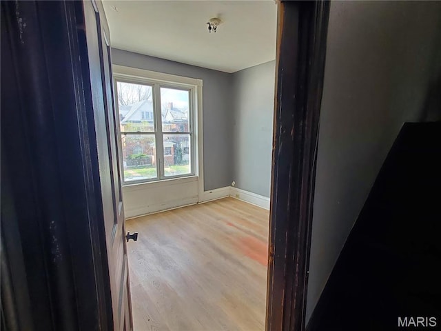 empty room with wood finished floors and baseboards