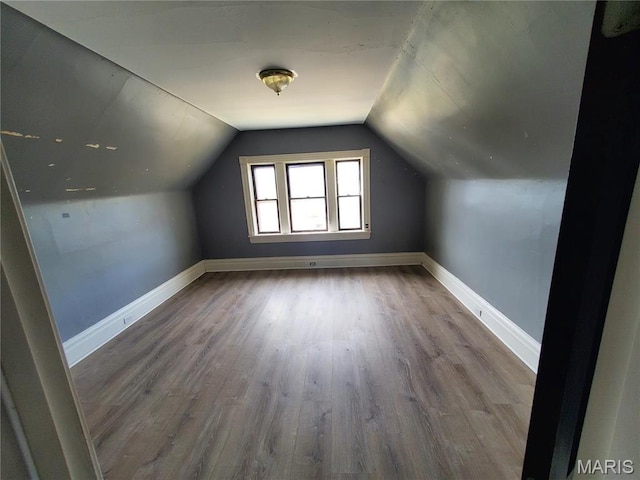 bonus room with wood finished floors, baseboards, and lofted ceiling