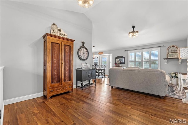 living room featuring vaulted ceiling and wood finished floors