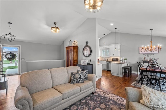 living room featuring a chandelier, wood finished floors, and high vaulted ceiling