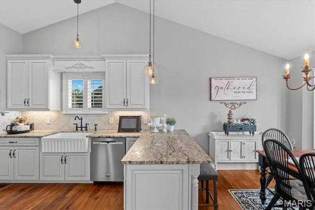 kitchen featuring stainless steel dishwasher, a kitchen bar, high vaulted ceiling, a peninsula, and backsplash
