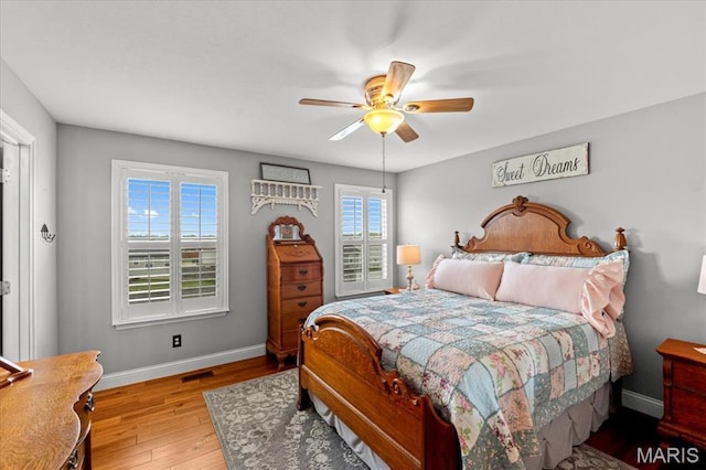 bedroom with baseboards, wood finished floors, and a ceiling fan