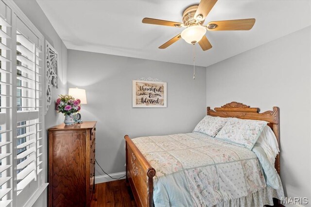 bedroom with wood finished floors, baseboards, and a ceiling fan