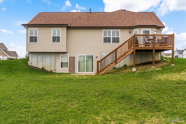 back of property with a deck, stairs, a lawn, and roof with shingles