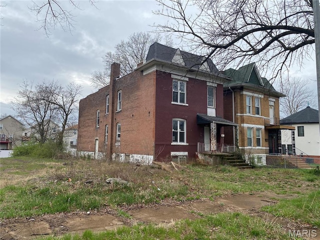 6010 Bartmer Ave, Saint Louis, MO 63112 - back of property with brick siding and a chimney