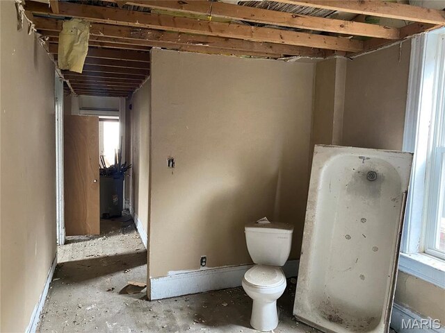 6010 Bartmer Ave, Saint Louis, MO 63112 - full bath featuring toilet, plenty of natural light, a tub to relax in, and baseboards