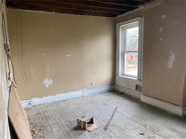 6010 Bartmer Ave, Saint Louis, MO 63112 - spare room with healthy amount of natural light, hardwood / wood-style floors, and baseboards