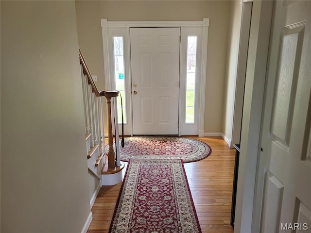 123 El Rancho Dr, Hannibal, MO 63401 - entrance foyer featuring light wood-style flooring, healthy amount of natural light, baseboards, and stairs