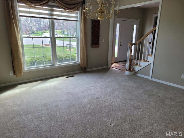 123 El Rancho Dr, Hannibal, MO 63401 - carpeted entryway with a chandelier, baseboards, and stairs