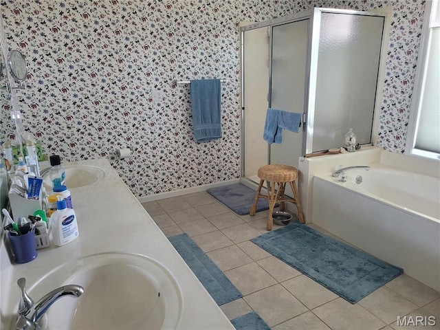 123 El Rancho Dr, Hannibal, MO 63401 - bathroom featuring wallpapered walls, a shower stall, a bath, double vanity, and tile patterned flooring