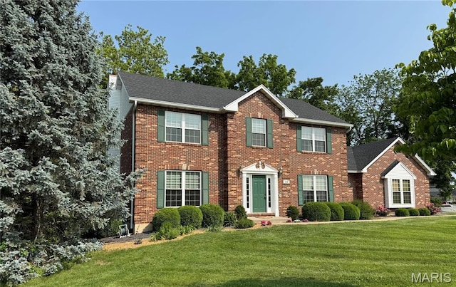 123 El Rancho Dr, Hannibal, MO 63401 - colonial house with a front yard and brick siding