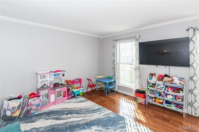 game room with ornamental molding, wood finished floors, and baseboards