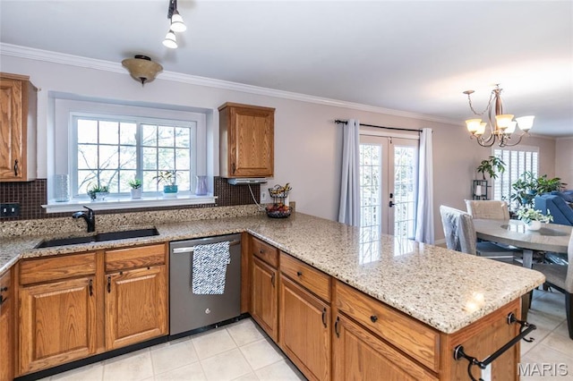 kitchen with stainless steel dishwasher, a sink, a peninsula, brown cabinetry, and light stone countertops