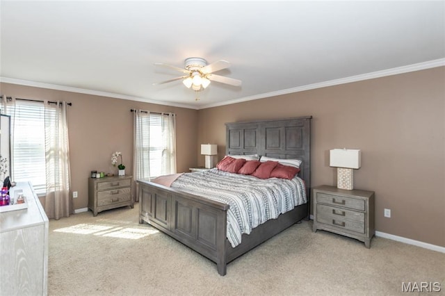 bedroom featuring light colored carpet, crown molding, baseboards, and ceiling fan