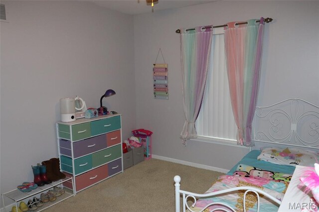 carpeted bedroom featuring baseboards