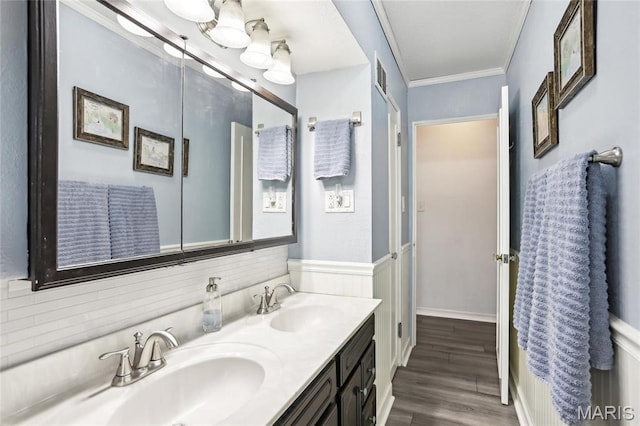 full bathroom with wood finished floors, crown molding, and double vanity