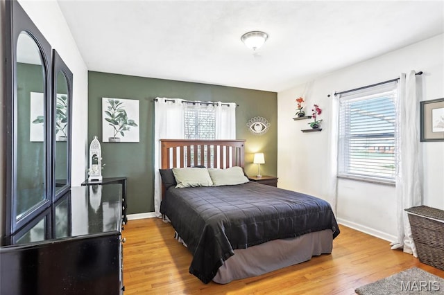 bedroom with wood finished floors and baseboards