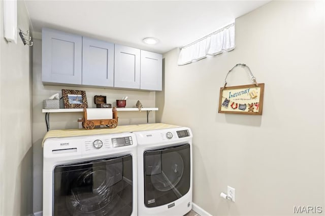 laundry room with independent washer and dryer, cabinet space, and baseboards