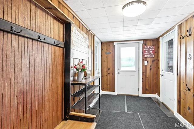 doorway featuring wooden walls