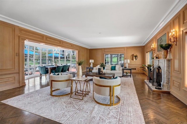 living room featuring ornamental molding, a fireplace with raised hearth, and a decorative wall