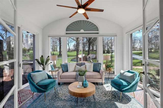 sunroom / solarium featuring vaulted ceiling, a ceiling fan, and an outdoor hangout area