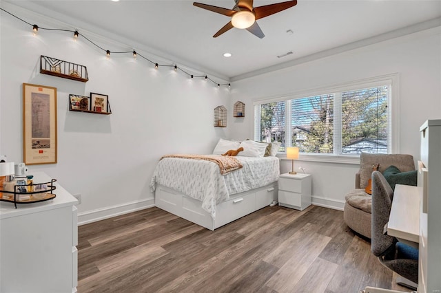 bedroom with baseboards, wood finished floors, and recessed lighting